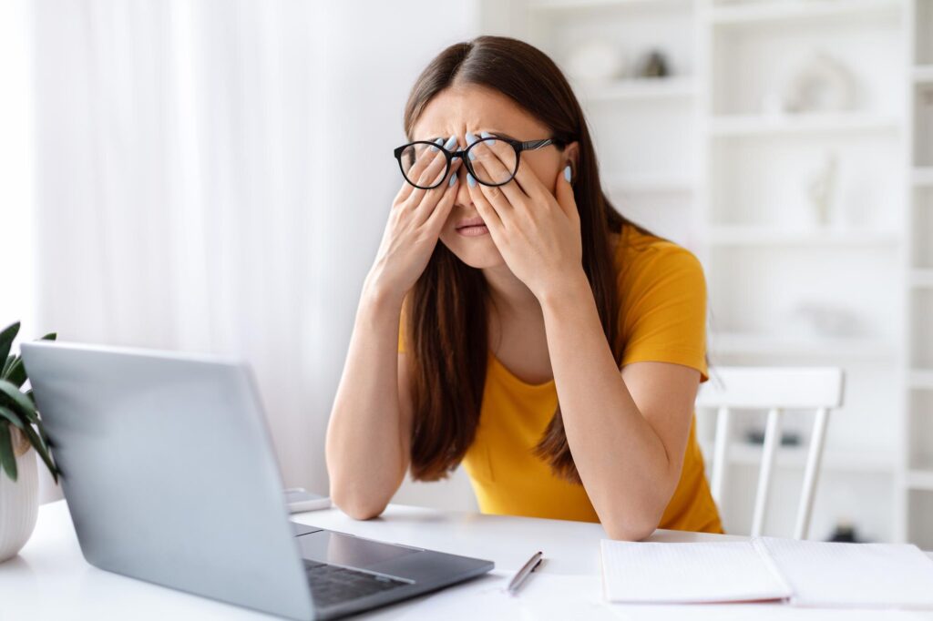 woman touching eyes fatigue