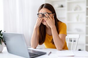 woman touching eyes fatigue