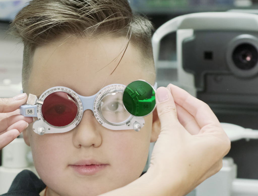 Child getting color vision test with red-green lenses